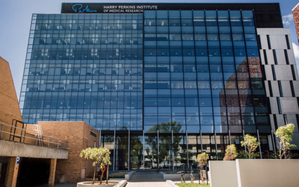 The Harry Perkins Institute of Medical Research building in Perth, glass facade in afternoon light.